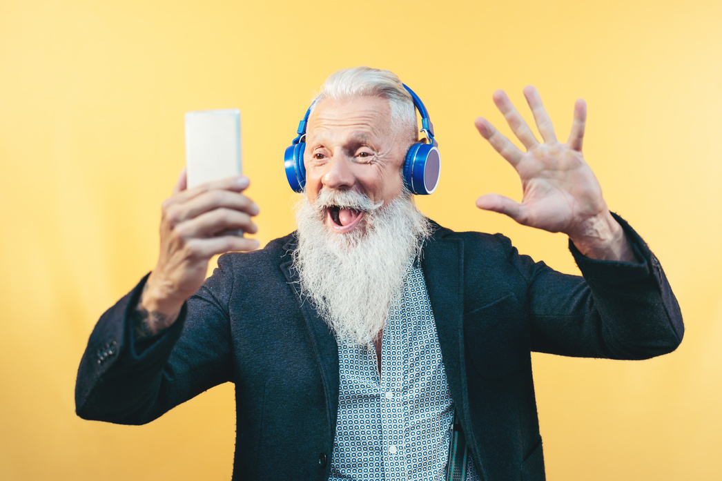 Happy Senior Man Taking Selfie While Listening Music 